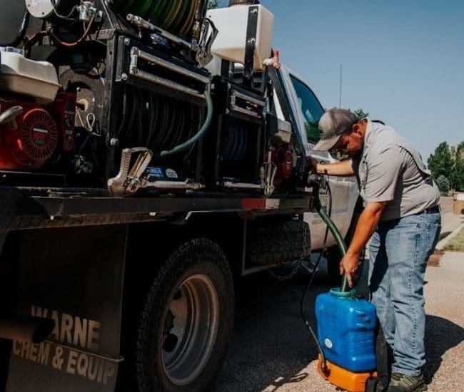 Warne Green Force filling tank with product to eliminate weeds from lawn
