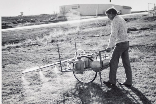Historic Warne photo of person spraying for weeds