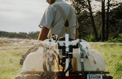 Warne Green Force employee spraying for noxious weeds
