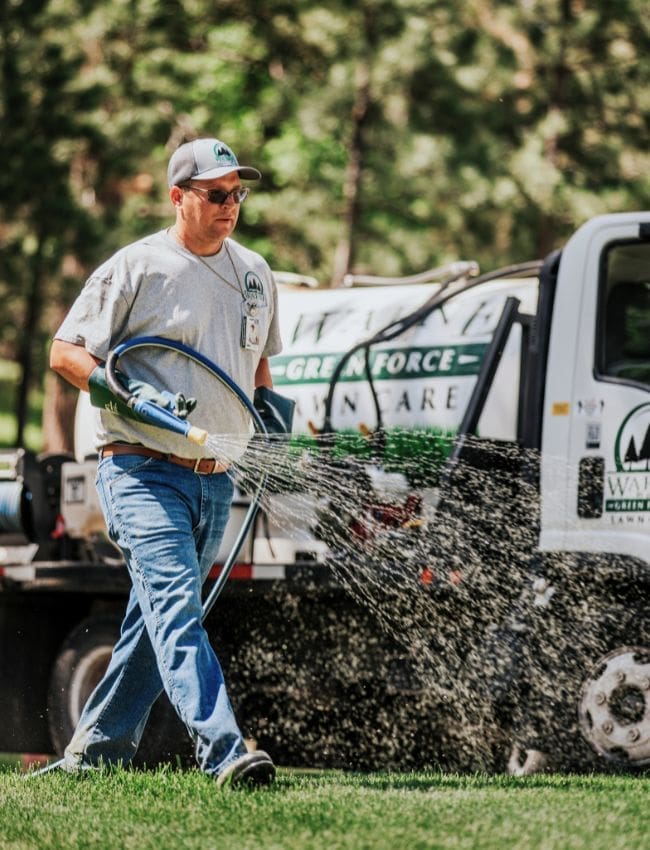 Warne Green Force worker spraying a landscape
