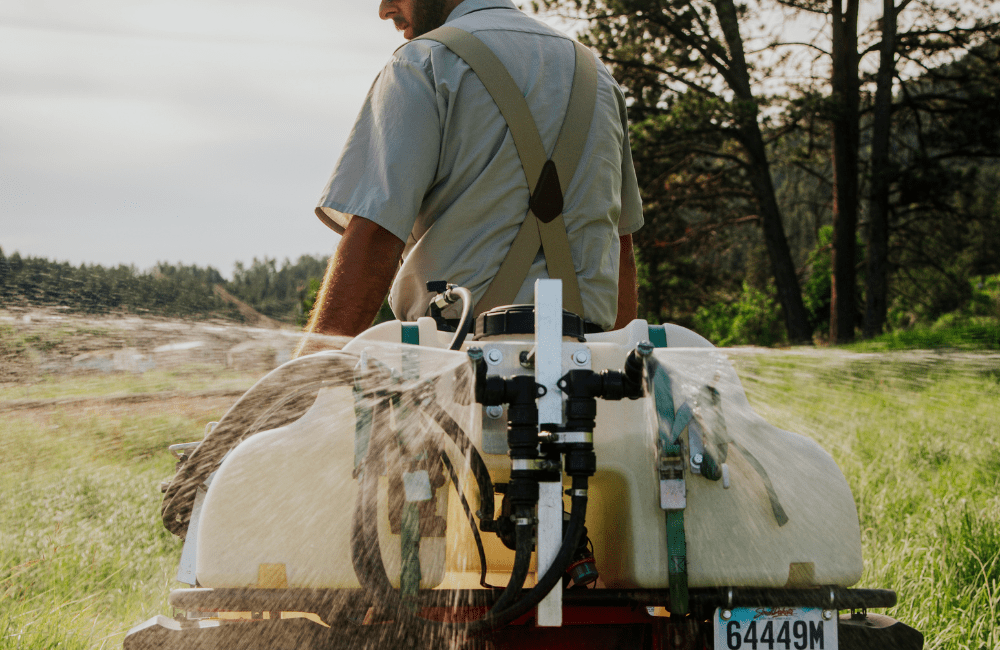 Warne Green Force employee spraying for noxious weeds