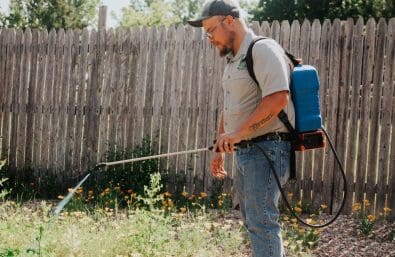 Bare Ground Small Warne Green Force employee spraying for weeds durin bare ground service